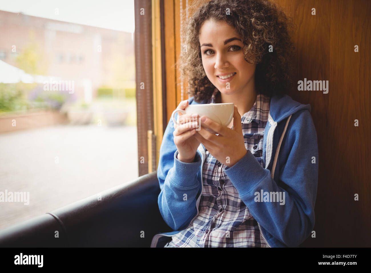Pretty student sitting by the window Stock Photo