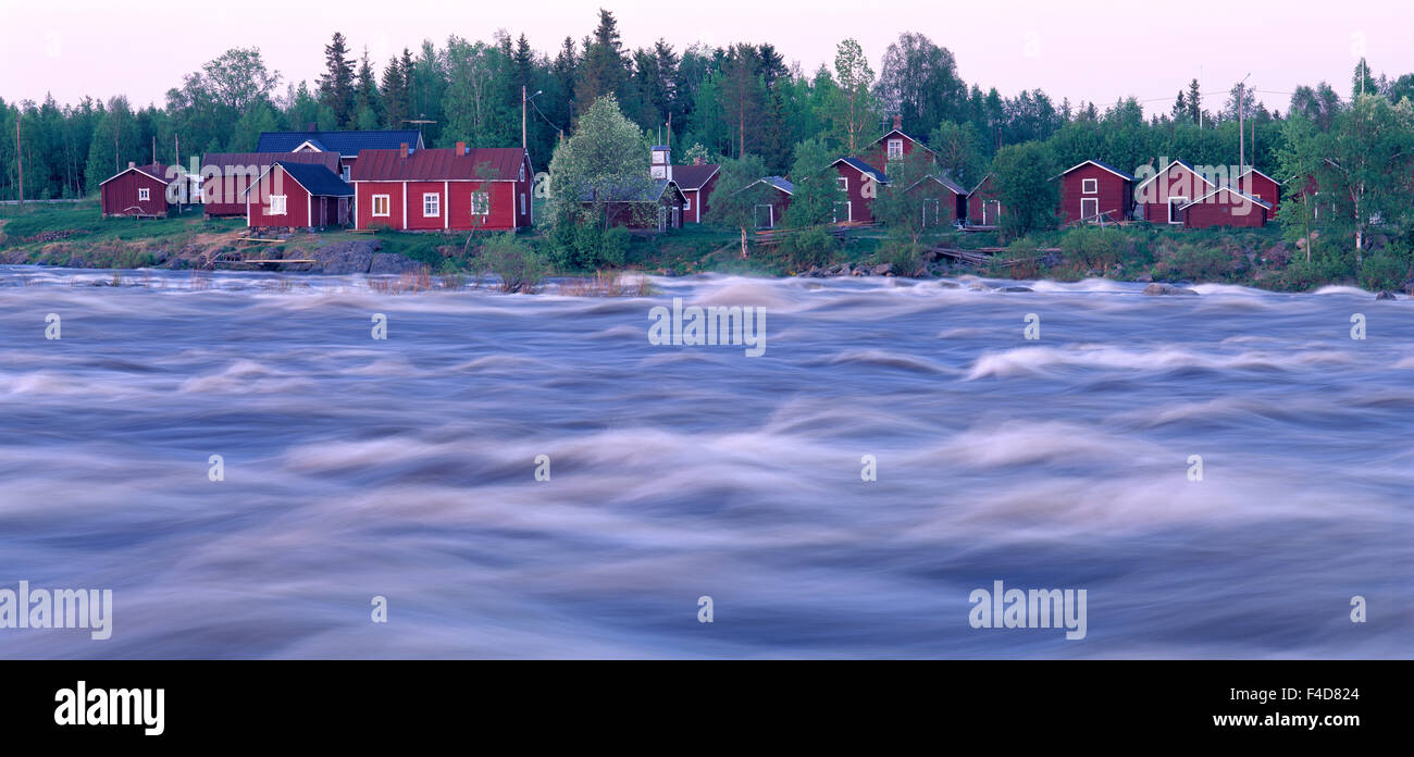 Cottages by a rapids. Stock Photo