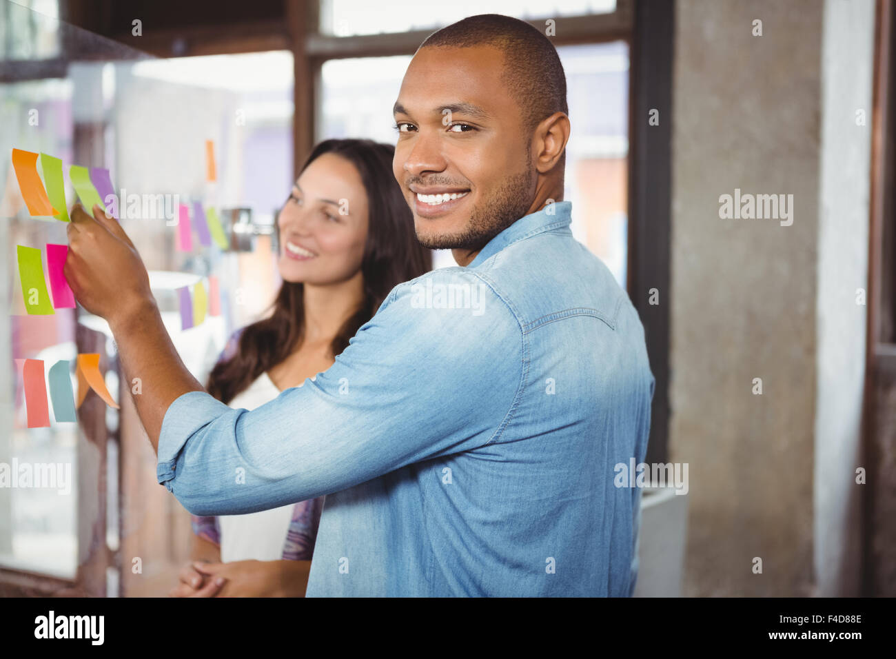 Smiling man with female colleague at office Stock Photo