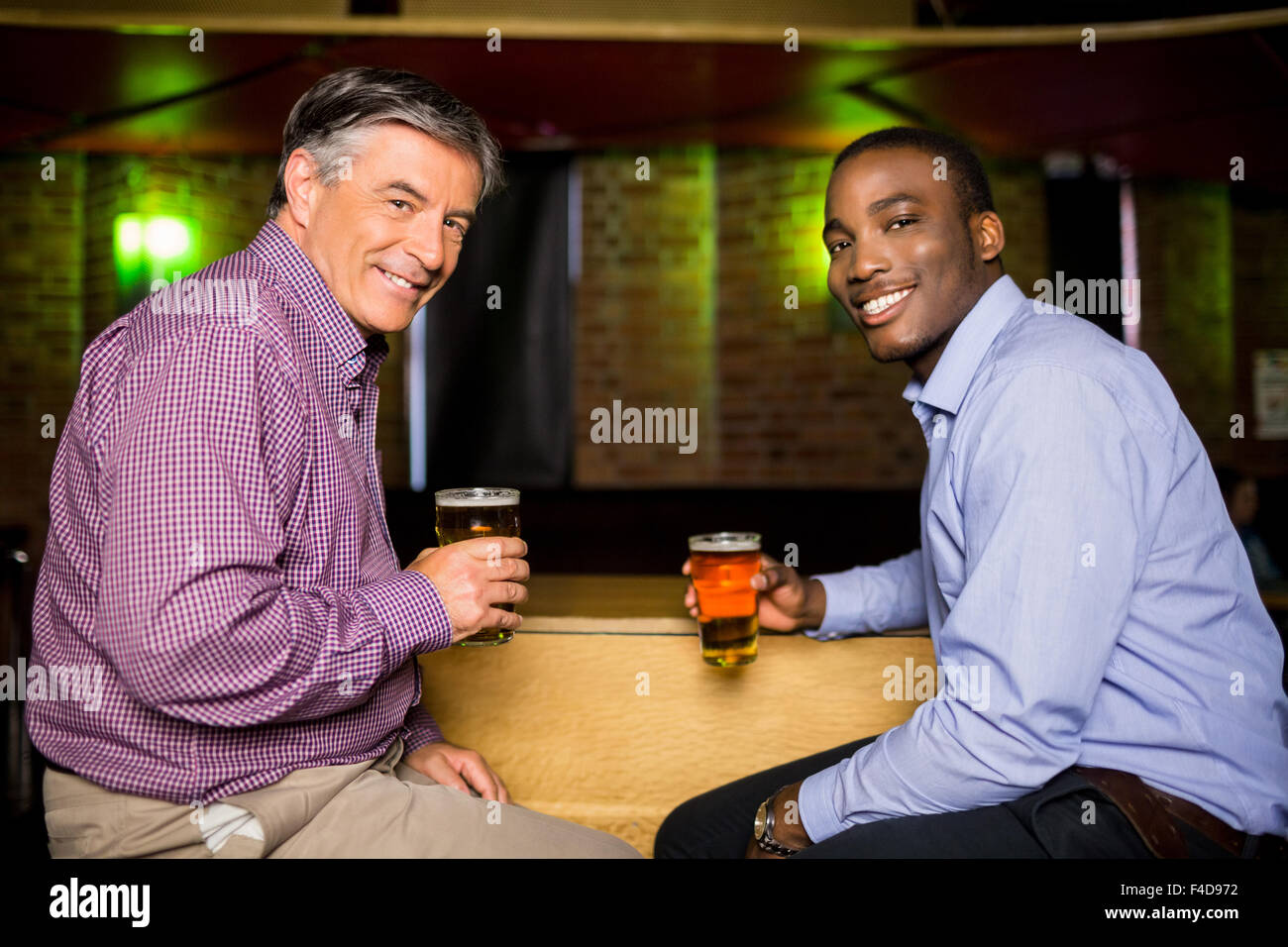 Smiling colleagues having a drink together Stock Photo