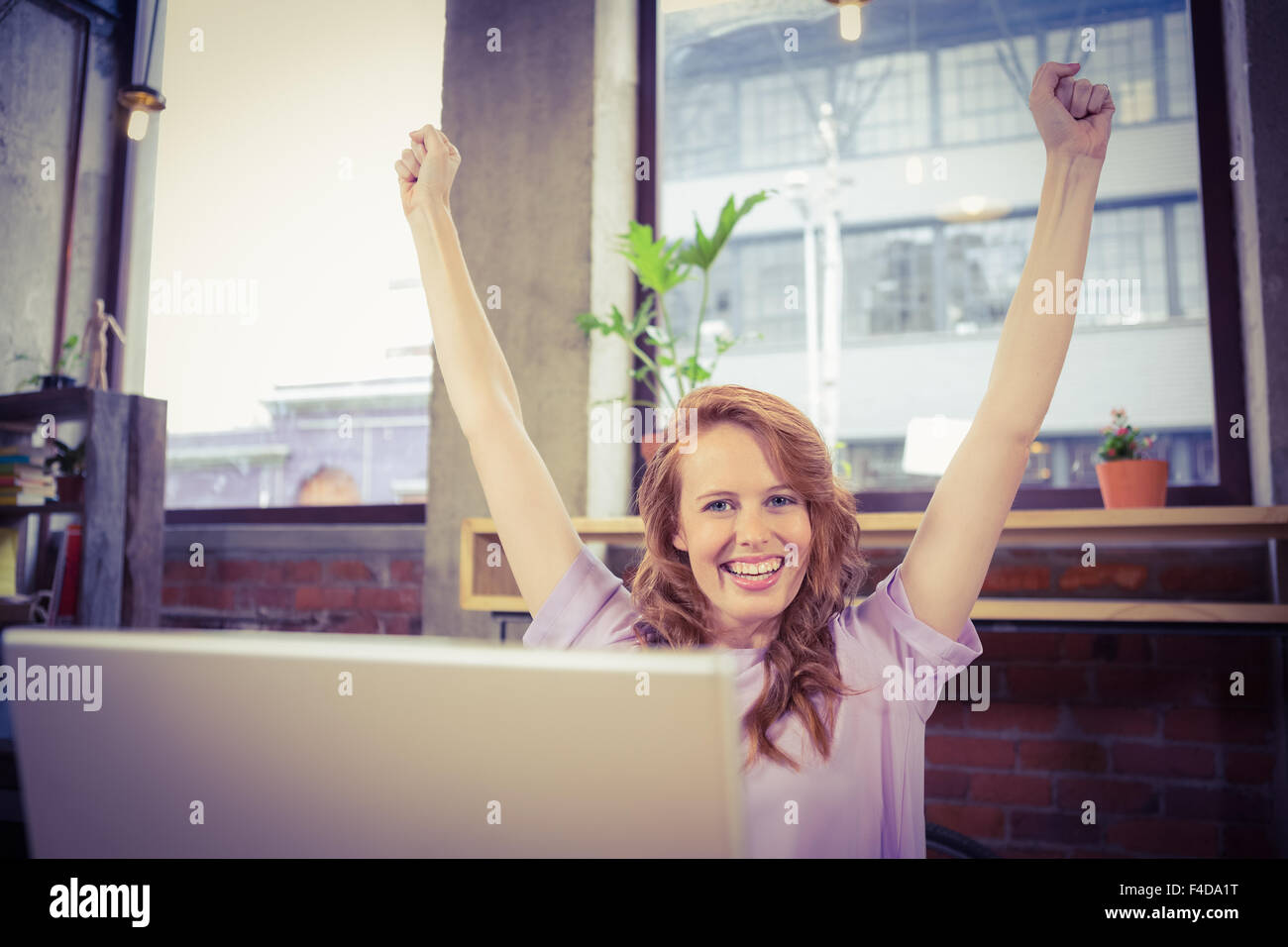 Portrait of happy woman with hands raised Stock Photo