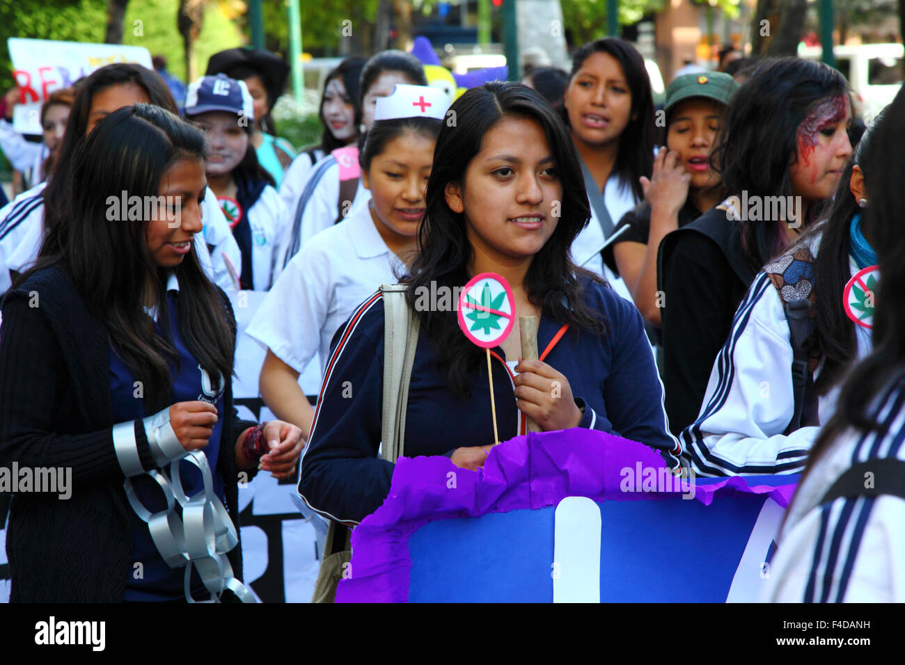 La Paz, Bolivia, 16th October 2015. A female student carries a 'No Marijuana' sign during a march through La Paz city centre warning of the dangers of drug use. The demonstration is organised every year by the police together with schools and colleges to educate and raise awareness about drugs and their dangers. Credit: James Brunker / Alamy Live News Stock Photo