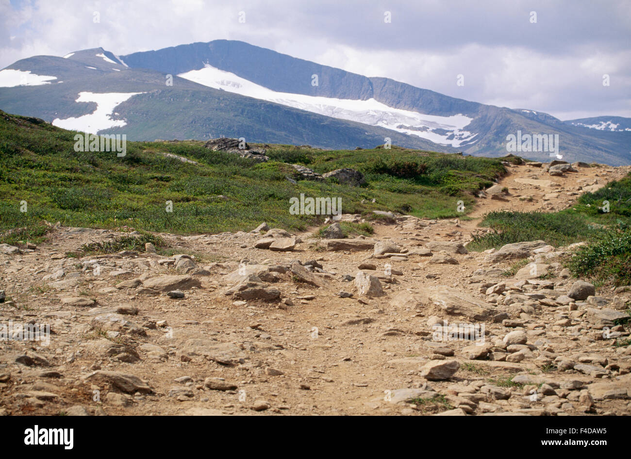 Barren land with mountain range in background Stock Photo