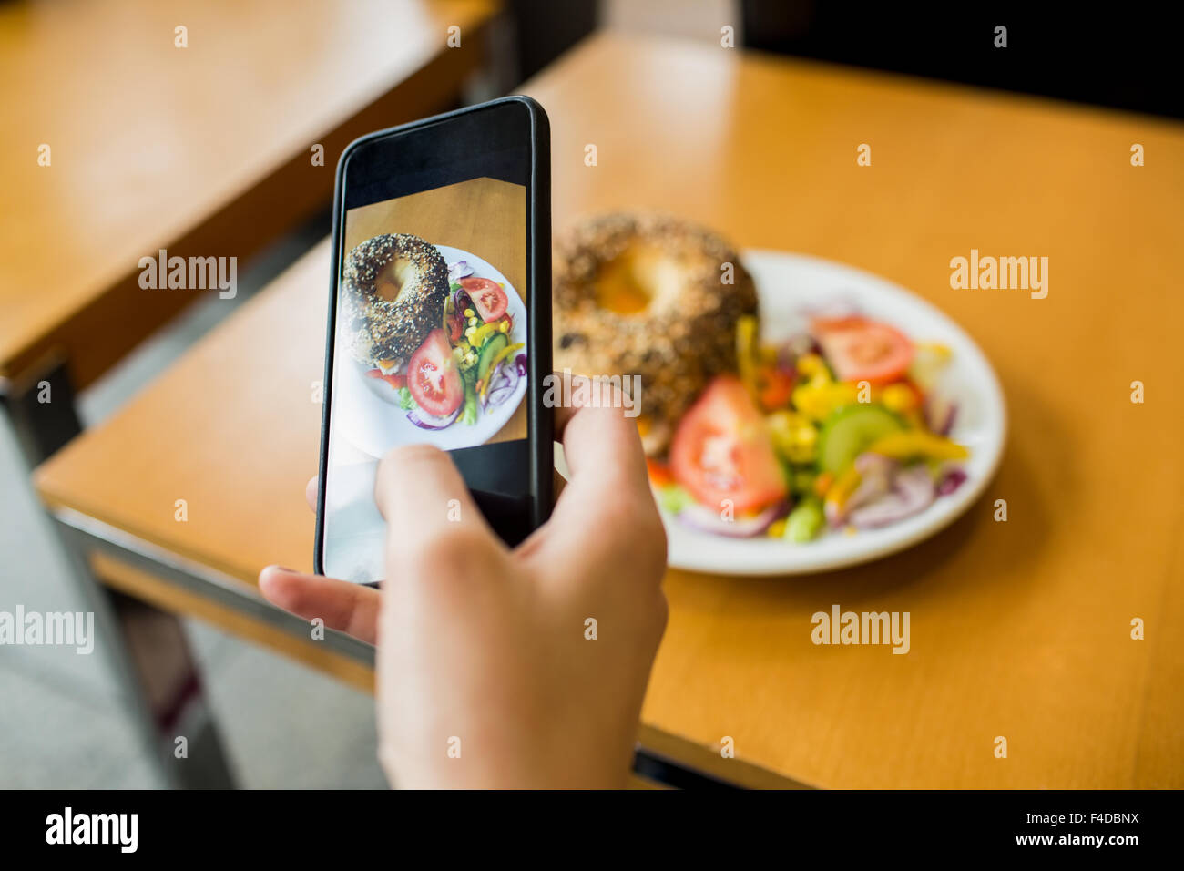 Woman photographing her lunch Stock Photo