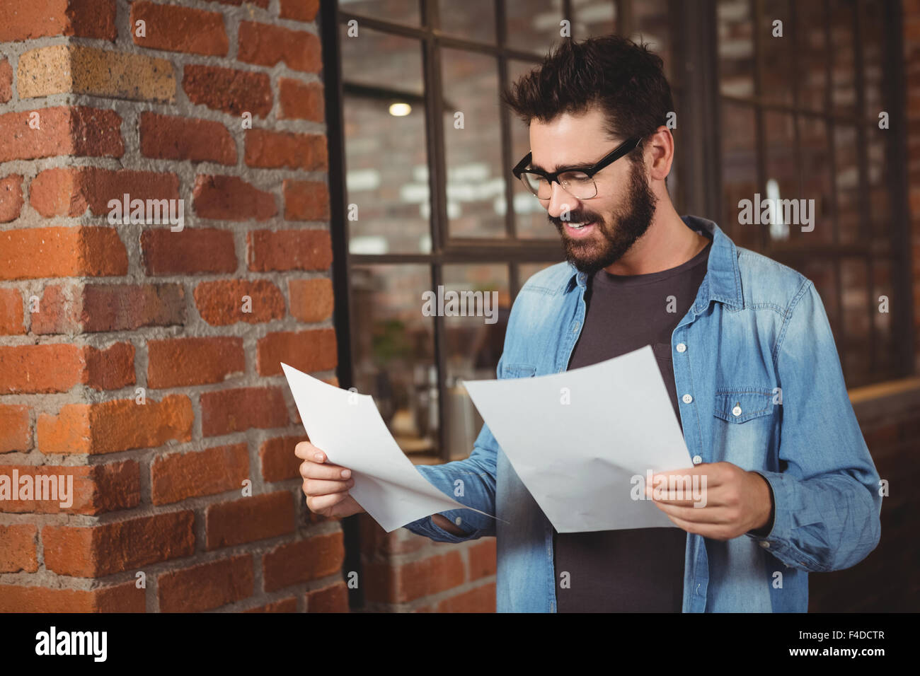 Happy man holding papers Stock Photo