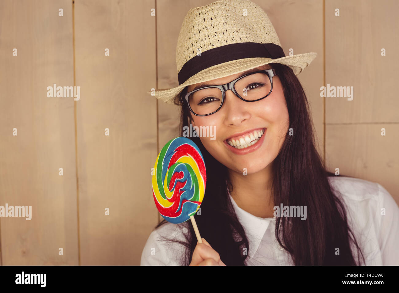 Pretty hipster with hat and lollipop Stock Photo