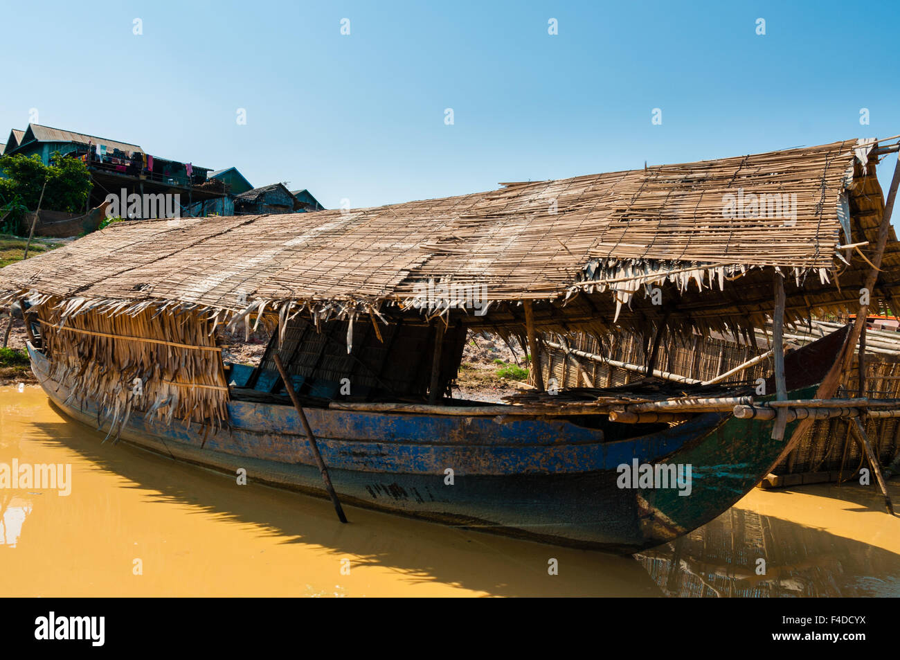 Wooden boat on muddy river Stock Photo
