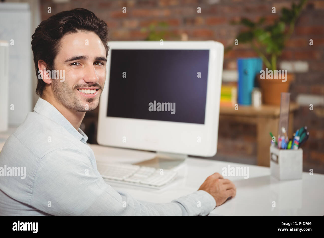 https://c8.alamy.com/comp/F4DF6G/handsome-man-sitting-at-office-desk-F4DF6G.jpg