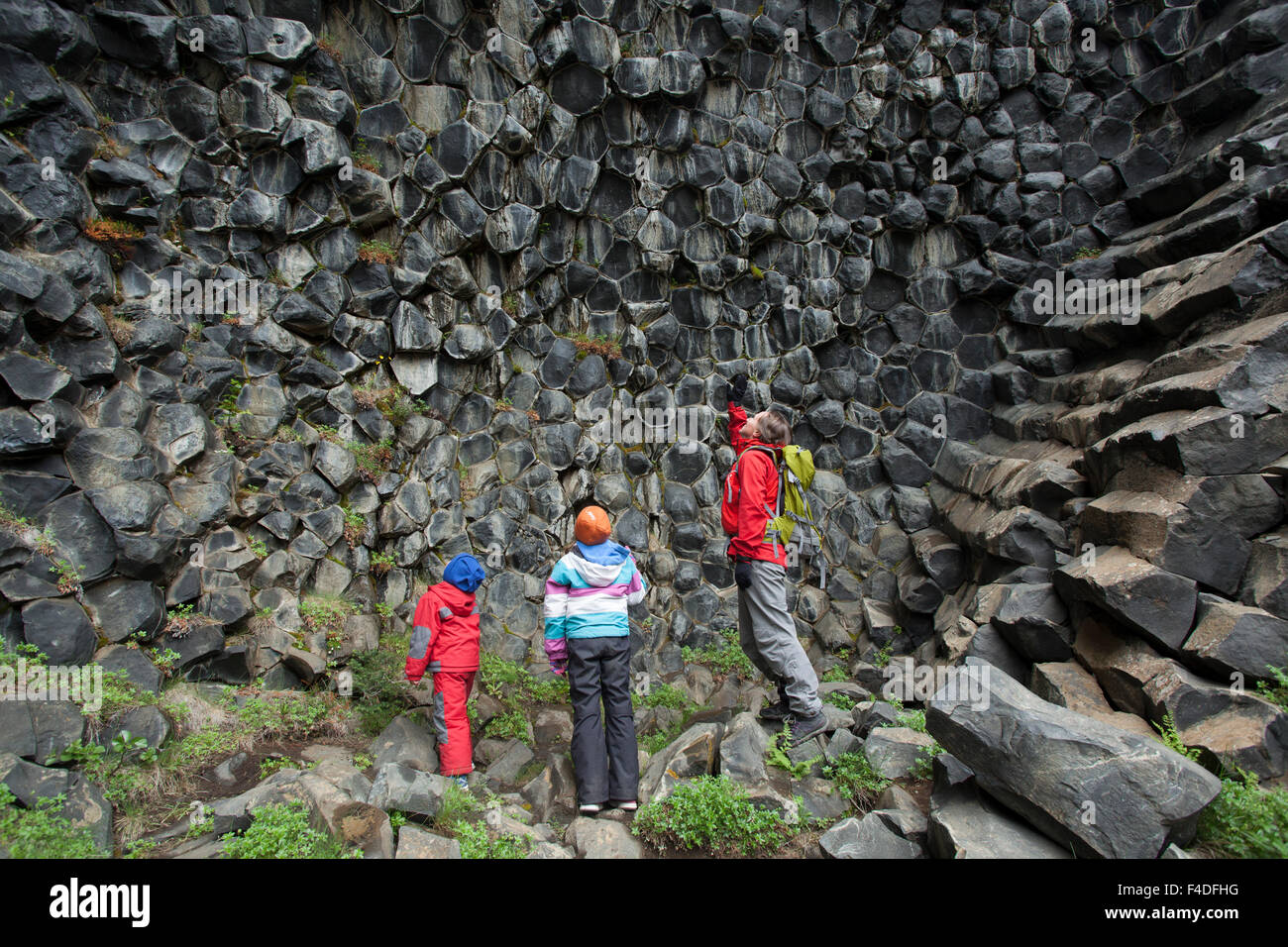Family studying basalt rock formations at Hljodaklettar, Jokulsargljufur, Nordhurland Eystra, Iceland. Stock Photo