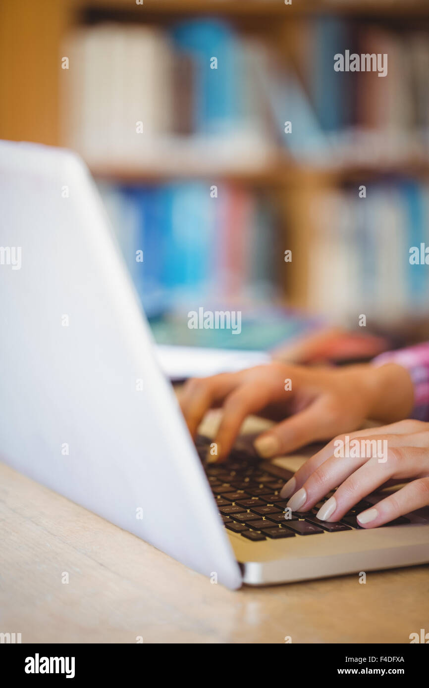 Female student typing on laptop Stock Photo