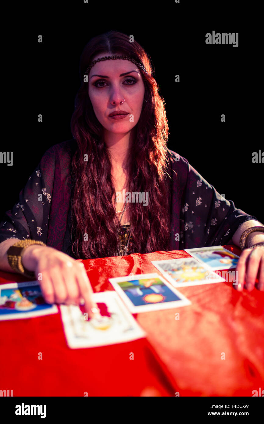 Portrait of fortune teller pointing at tarot card Stock Photo