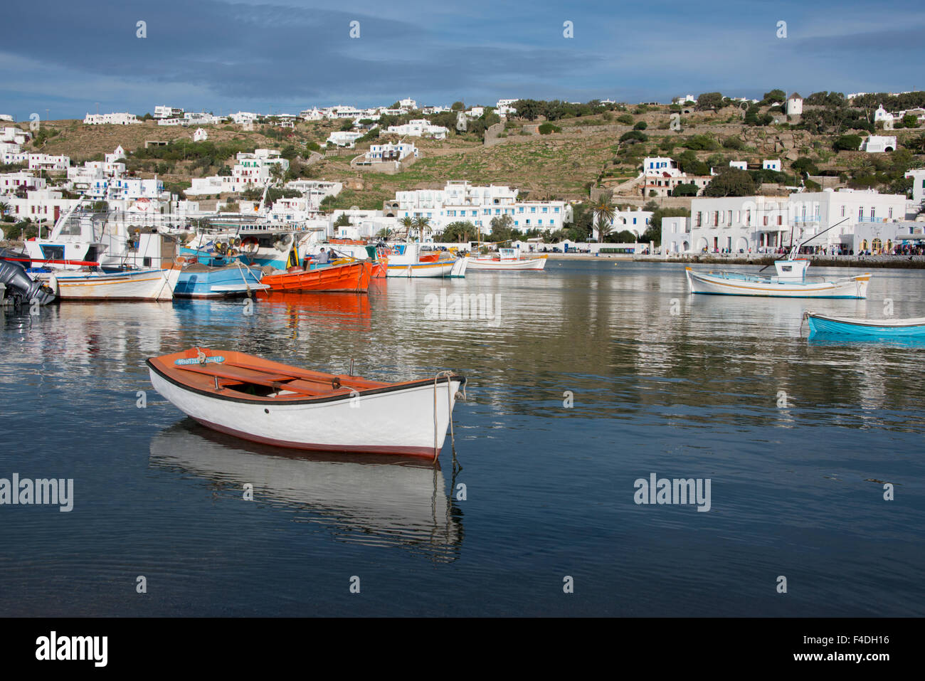 Greece, Cyclades, Mykonos, Hora. Port and harbor area with Greek fishing boats. Island countryside and local fishermen in the distance. (Large format sizes available). Stock Photo