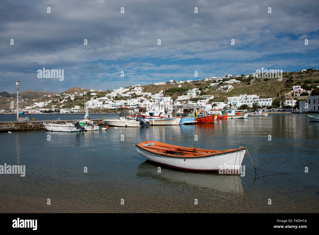 Greece, Cyclades, Mykonos, Hora. Port and harbor area with Greek fishing boats. Island countryside in the distance. (Large format sizes available). Stock Photo