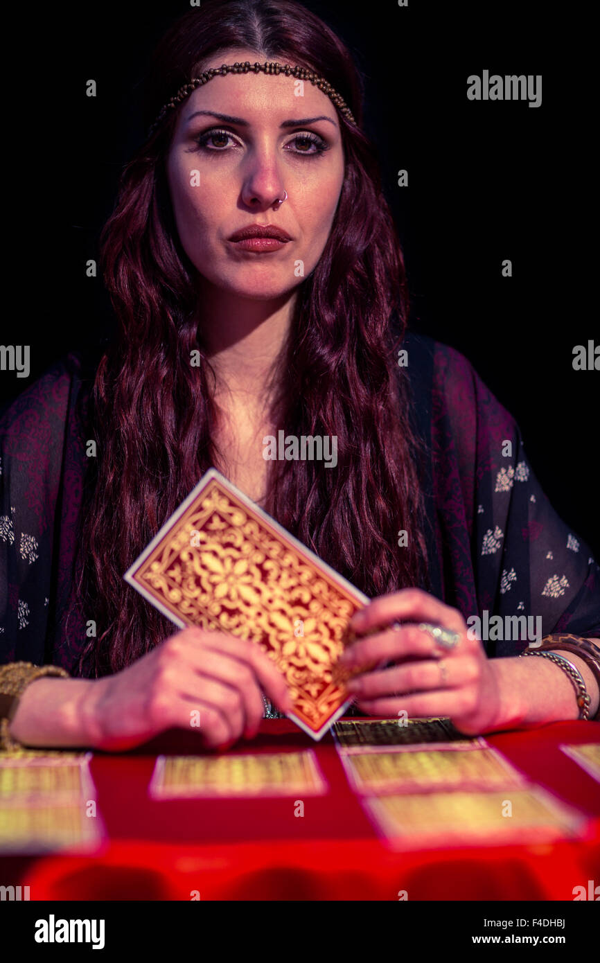 Portrait of fortune teller holding tarot cards Stock Photo