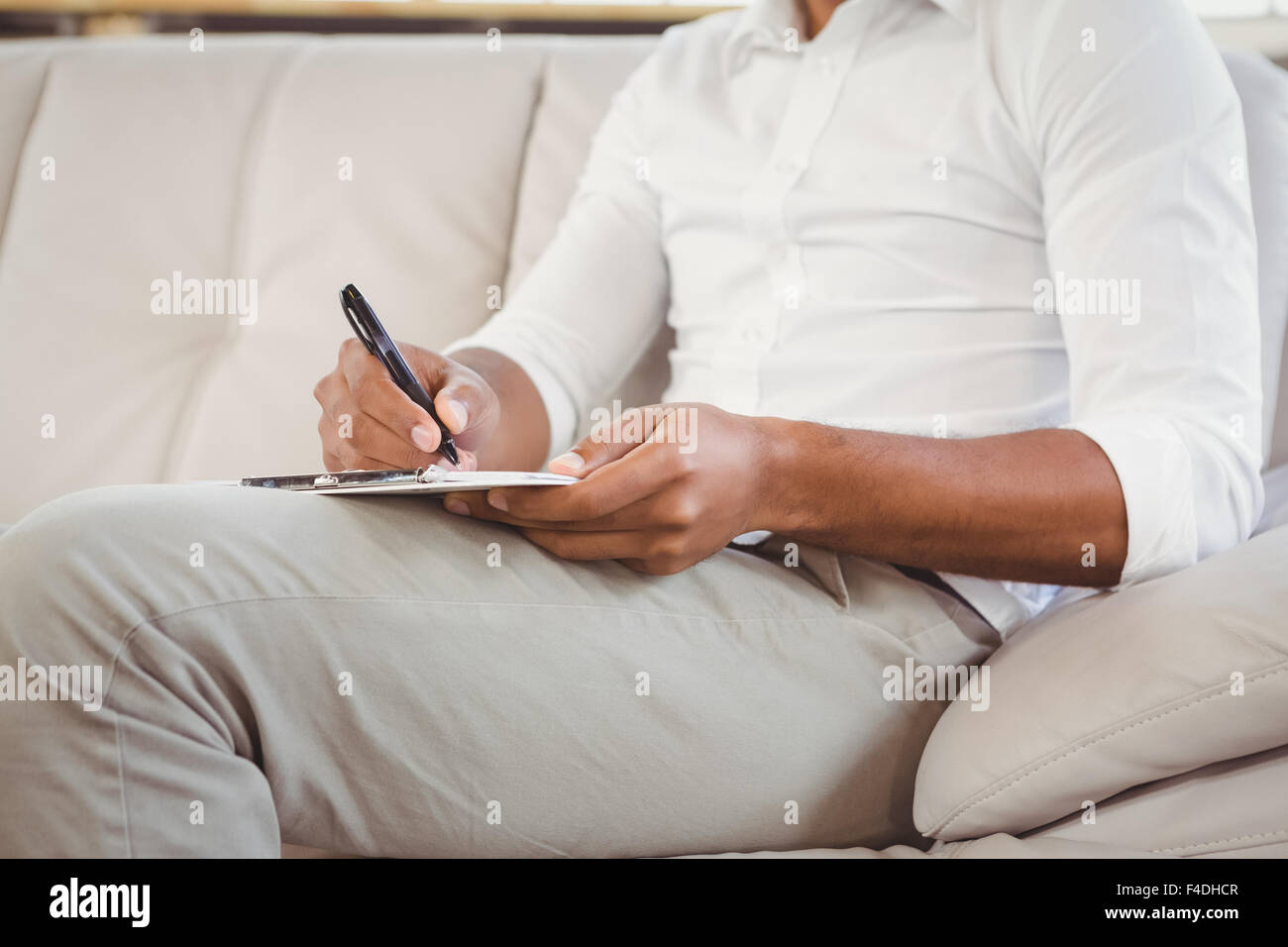 Therapist writing on book at clinic Stock Photo Alamy