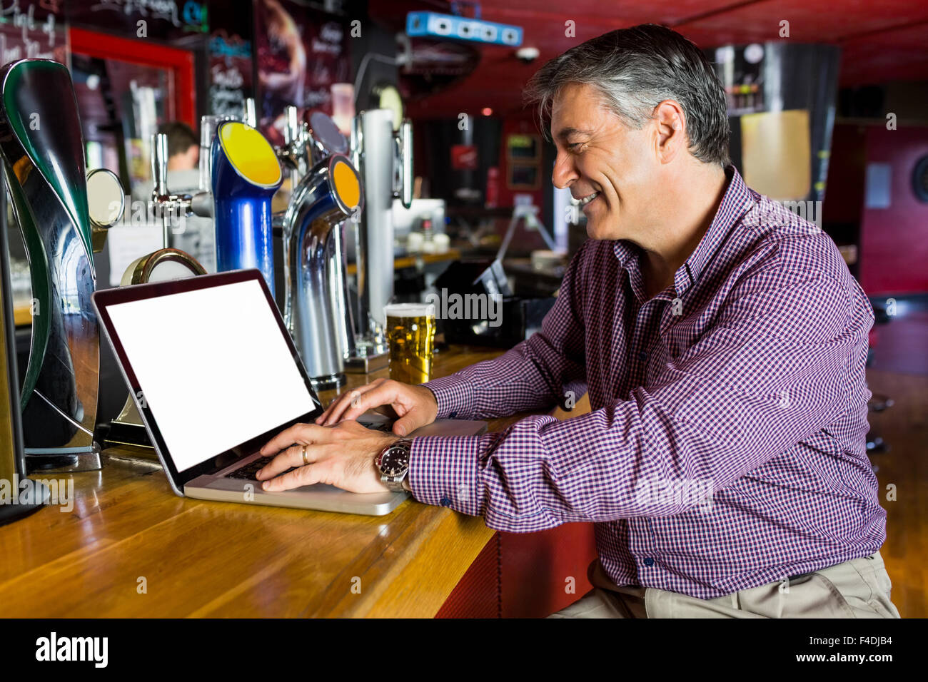 Man with grey hair using his laptop Stock Photo