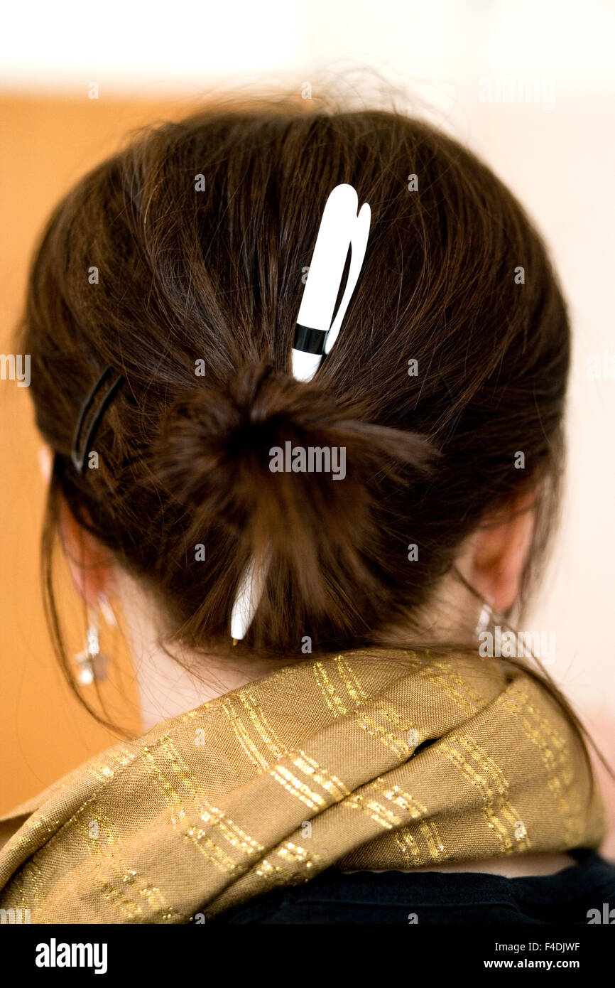 A pen in a hair bun Stock Photo - Alamy