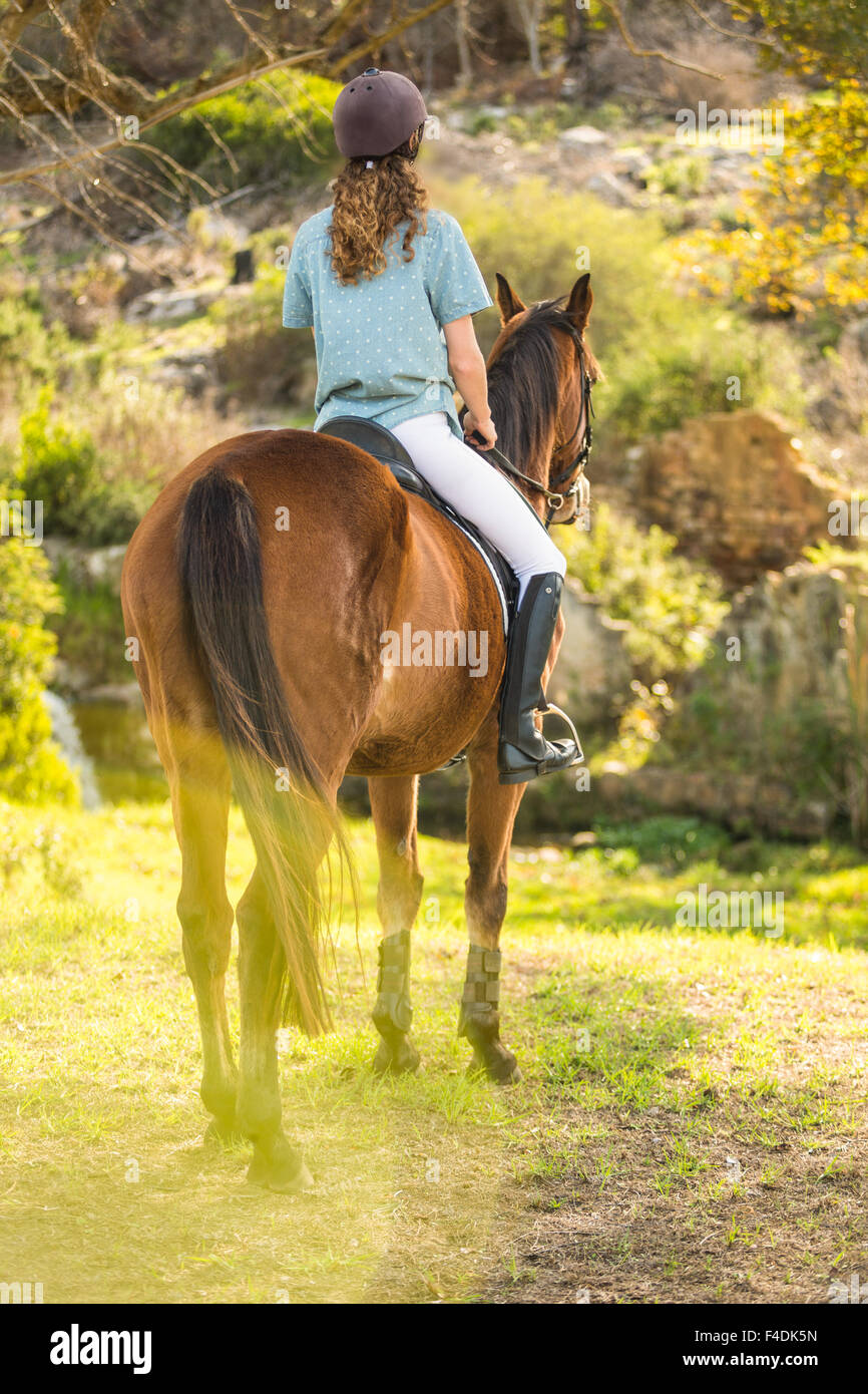 Young woman riding her horse Stock Photo - Alamy
