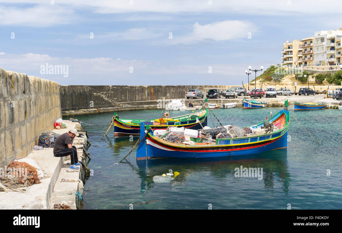 The island of Gozo in the Maltese archipelago. The former fishing village Marsalforn with modern hotel buildings and traditional fishing boats called Luzzu in the harbor. Europe, Southern Europe, Malta. (Large format sizes available) Stock Photo