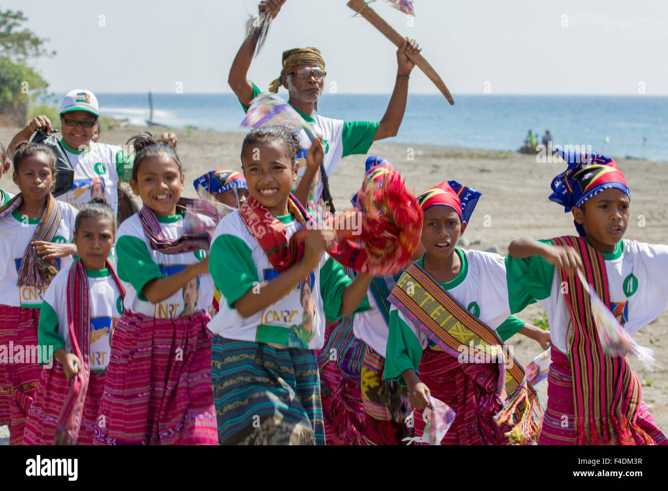 East Timorese children and chief wearing traditional clothes while heading to perform at an electoral campaign event in 2012 Stock Photo