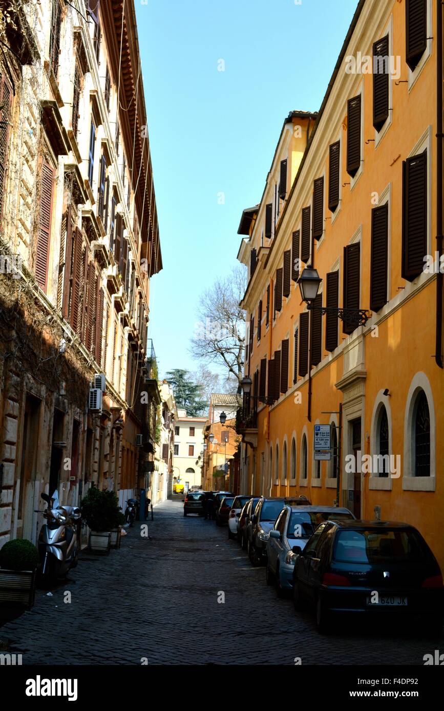 cars parked along a quiet narrow street in Rome, Italy Stock Photo