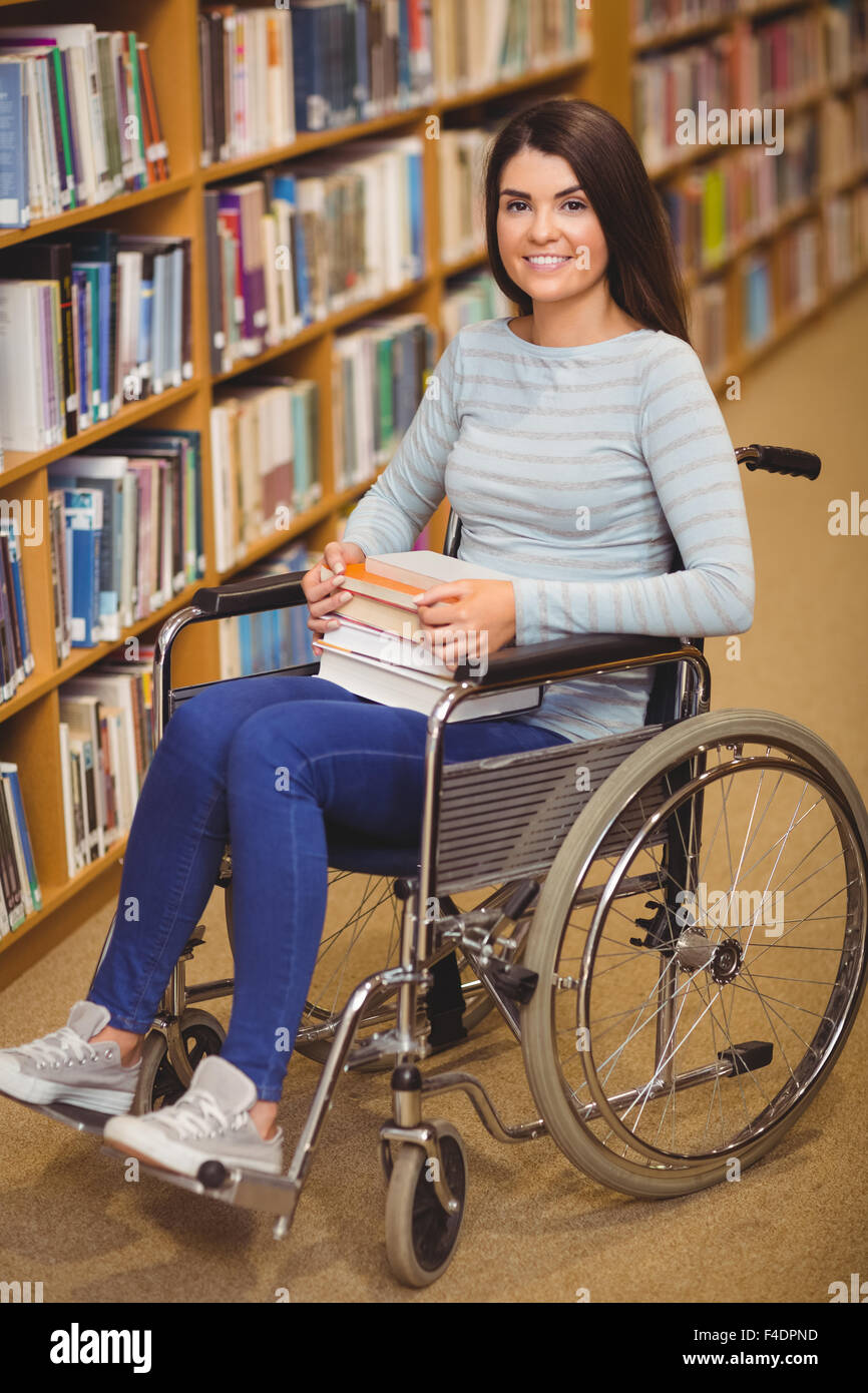 Happy disabled female student with books Stock Photo