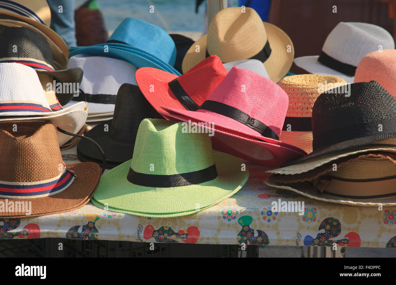 A table display of straw hats in the open air bazaar in Oporto. Stock Photo