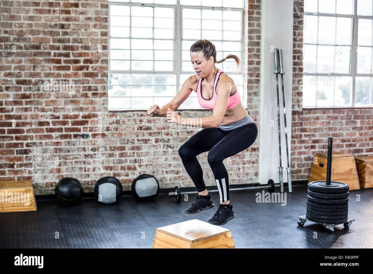 Fit woman doing jumping squats Stock Photo Alamy