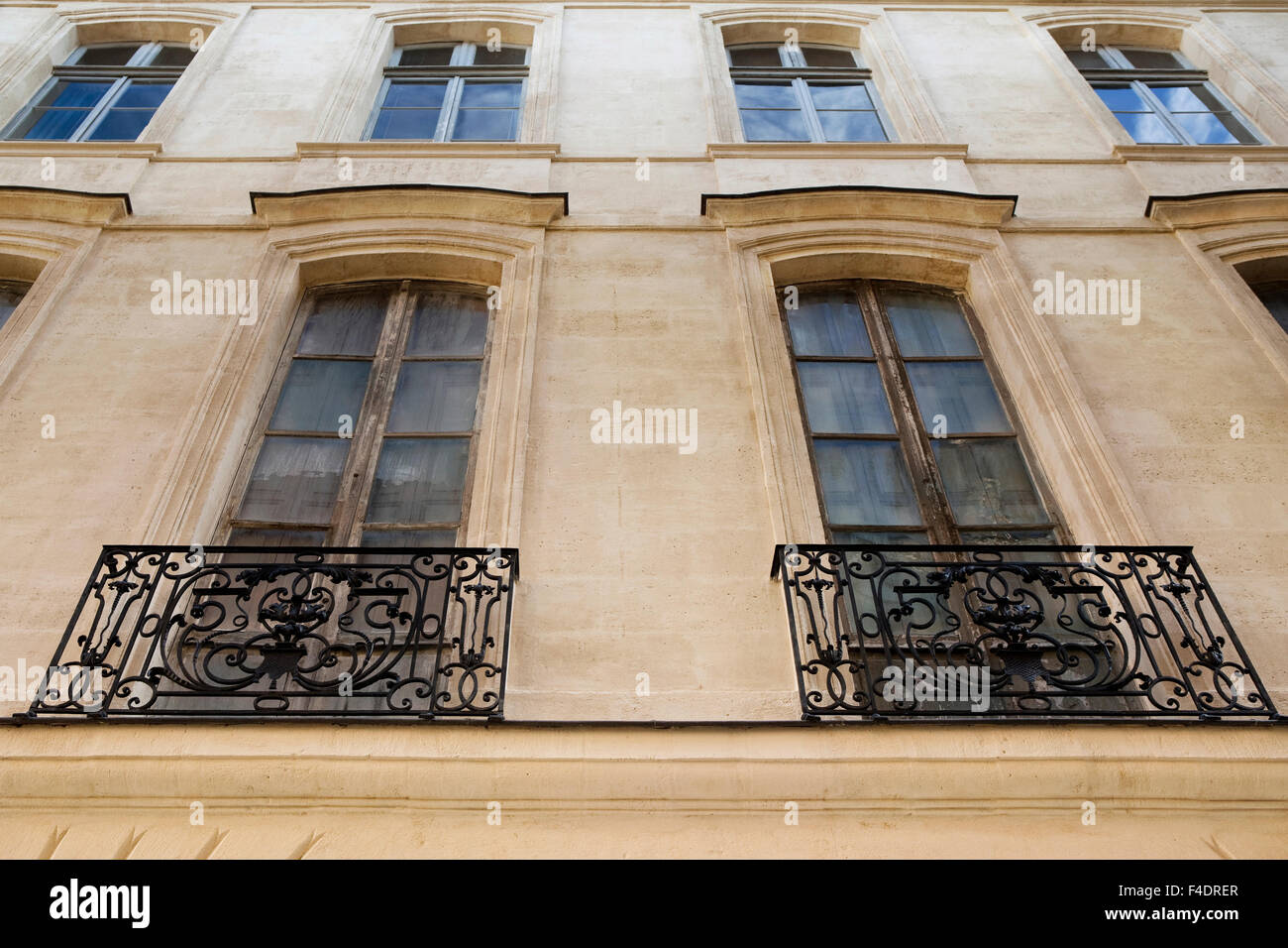 Windows and wrought iron balconies of a French classic facade Stock ...