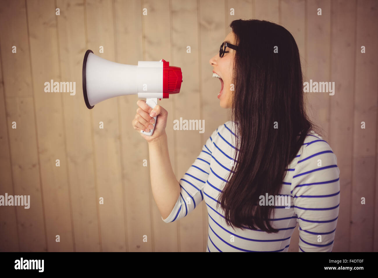 Beautiful woman shouting with megaphone Stock Photo