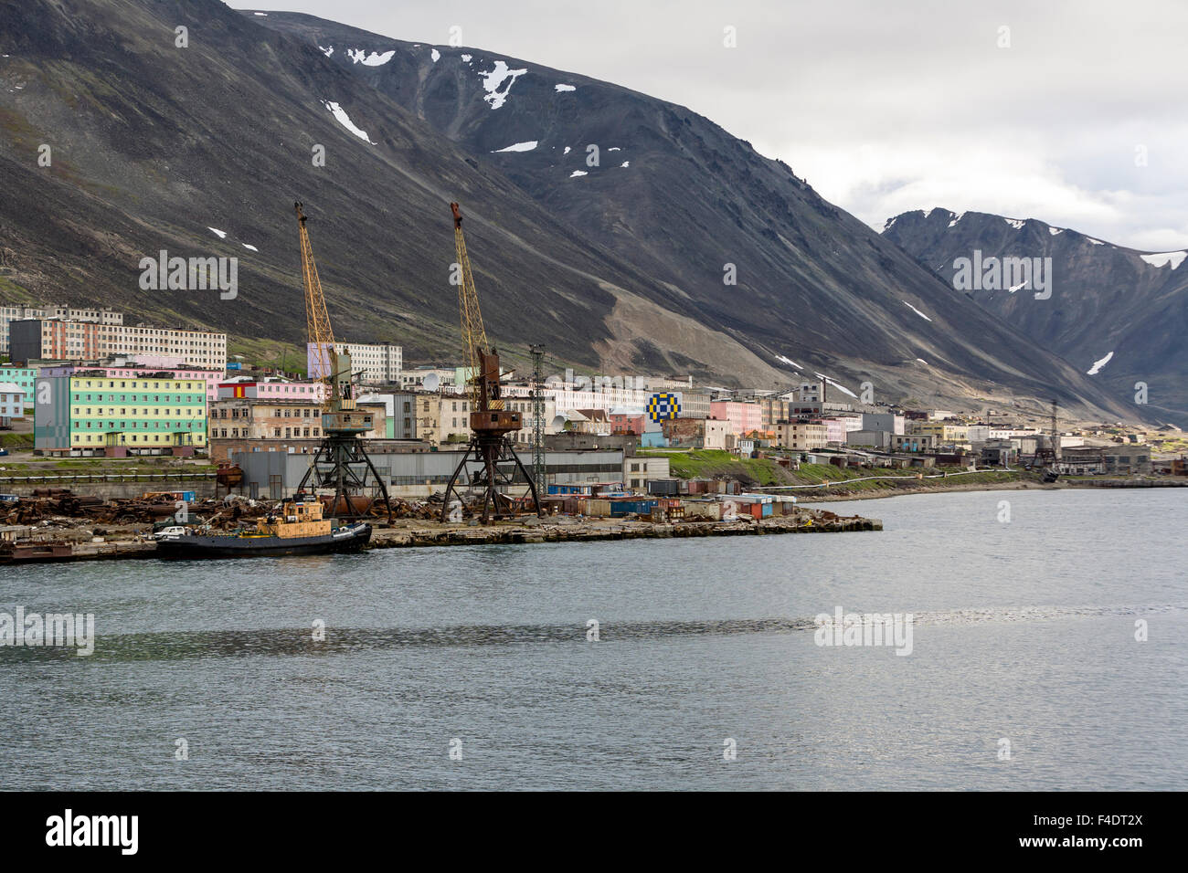 Russia, Chukotka, Provideniya, View of port and industrial buildings on ...