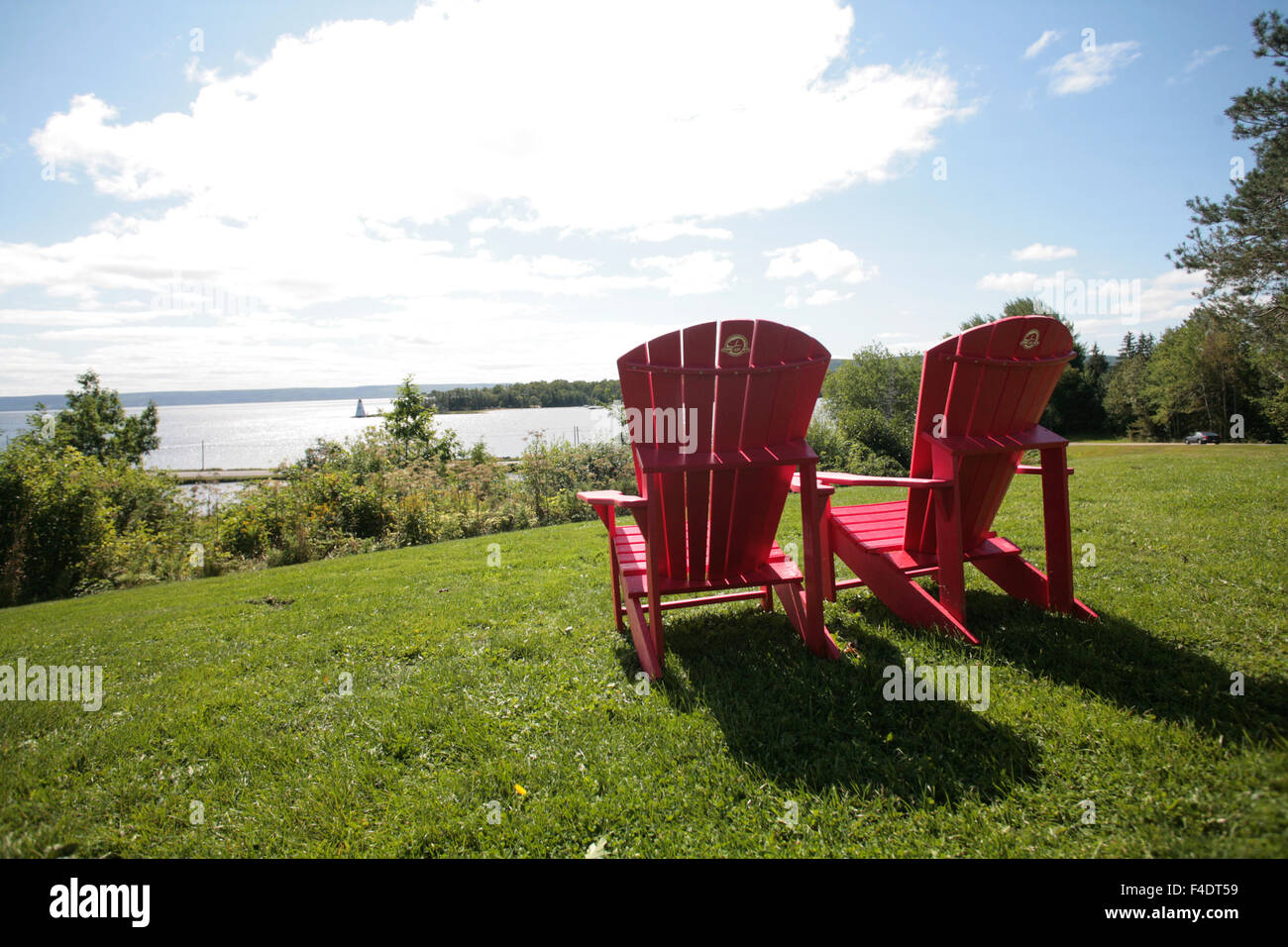 A pair of Parks Canada red chairs overlooking the bay in Baddeck, N.S