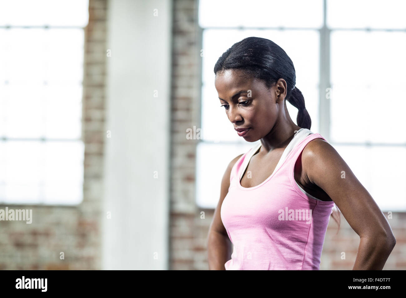 Serious muscular woman focused on herself Stock Photo