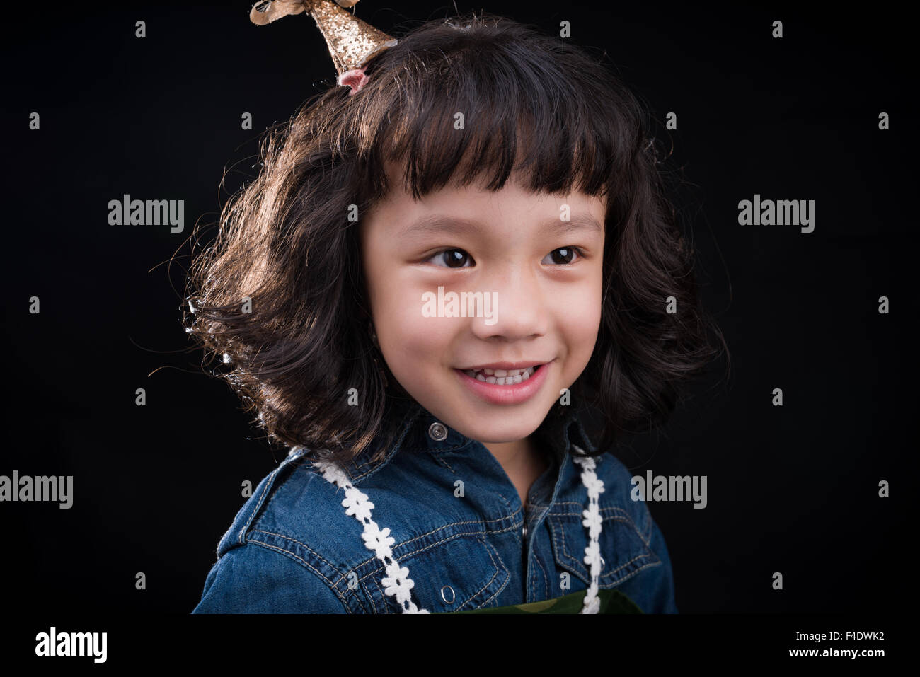 Lovely little girl sitting  joyfully in a studio in Xiangyang, Hubei province, China in 2015. ( All signed model reeases ) Wang Stock Photo