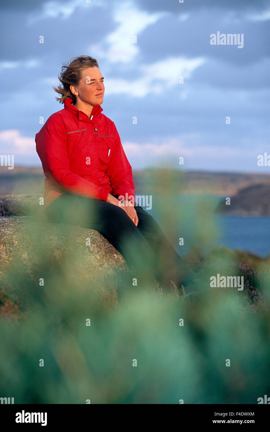 A woman sitting on a rock in the archipeago. Stock Photo