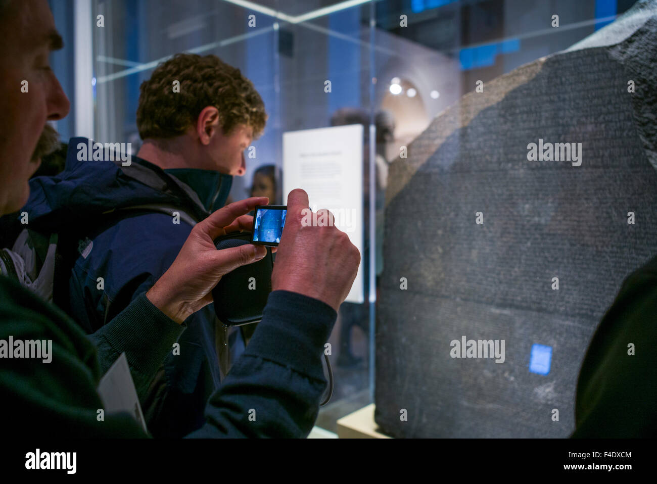 England, London, Bloomsbury, British Museum, Egyptian Room, Rosetta Stone, its discovery allowed the deciphering of the ancient Egyptian alphabet, being photographed by cell phone Stock Photo