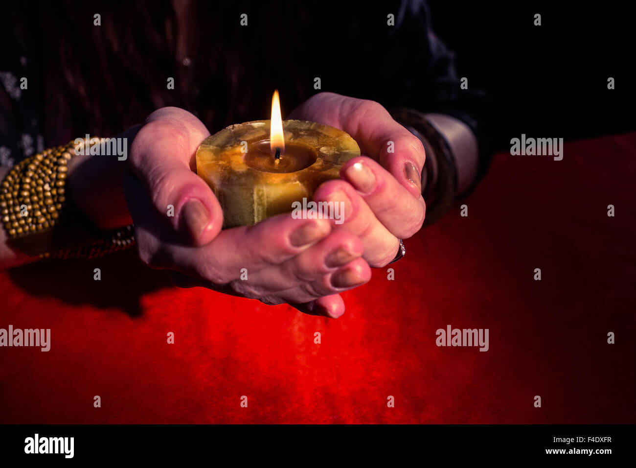 Fortune teller woman holding candle Stock Photo