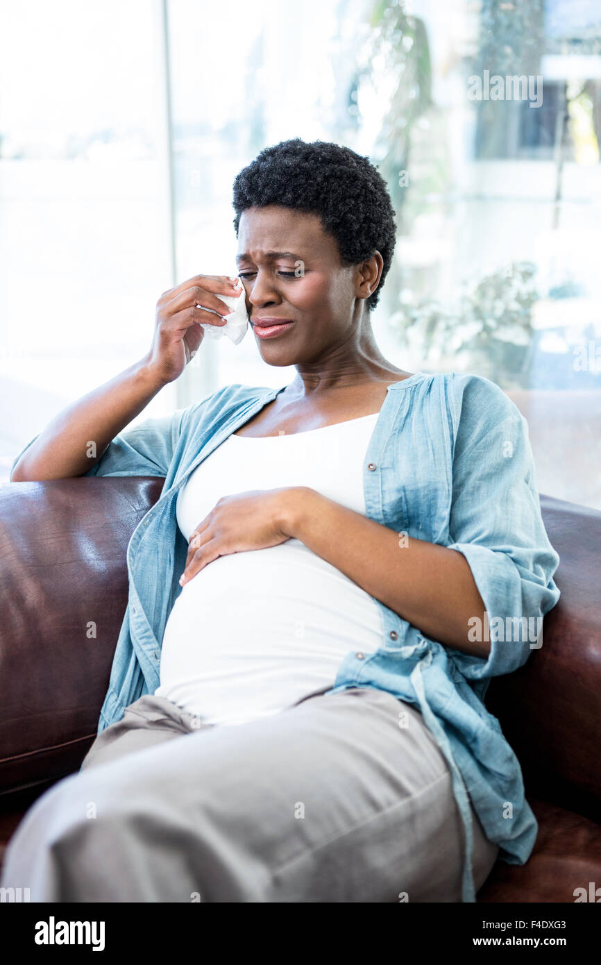 Pregnant woman crying from pregnancy pains Stock Photo