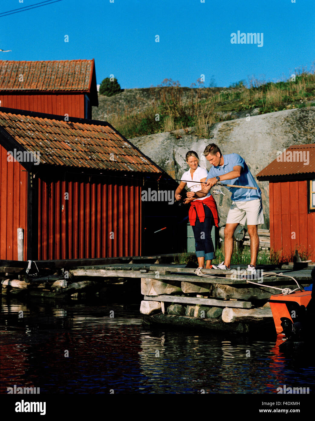 A man and a woman fishing, Harstena, Sweden. Stock Photo
