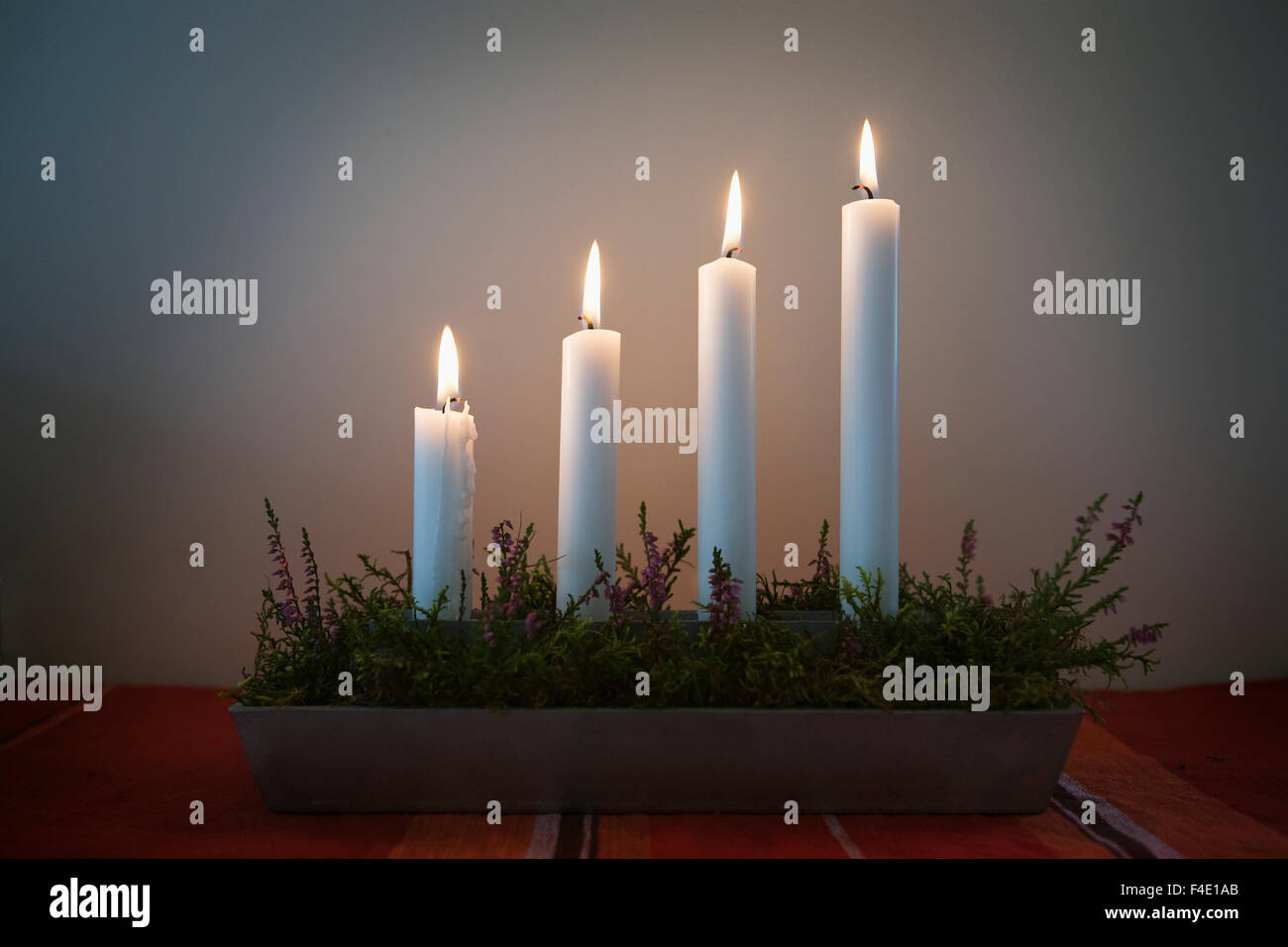 Advent candlestick with four candles lit in turn on each Sunday in