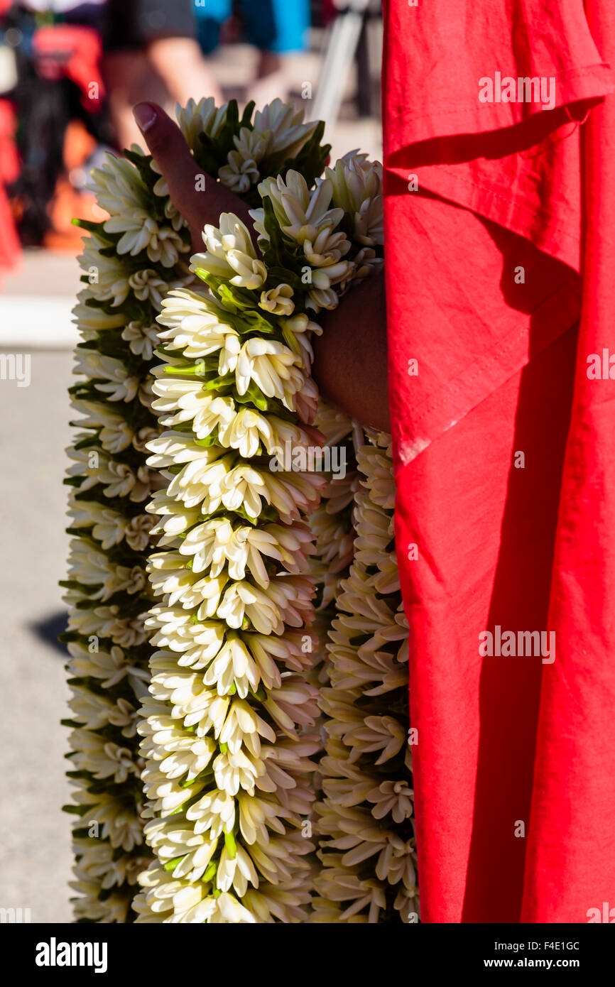 Pacific Ocean, French Polynesia, Society Islands, Huahine. Close-up shot of woman holding traditional Polynesian lei, locally called hei, made of Tahitian gardenias. Stock Photo