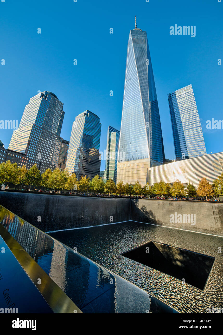 South pool in plaza at National September 11 Memorial with Freedom Tower in background, Manhattan, New York, USA - Stock Image