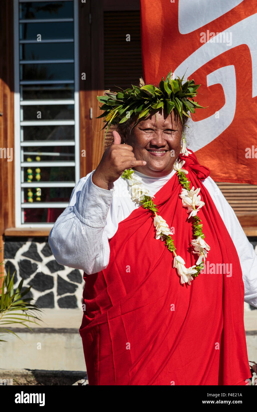 Pacific Ocean, French Polynesia, Society Islands, Huahine, Fare. Woman in traditional dress posing for photograph. Stock Photo