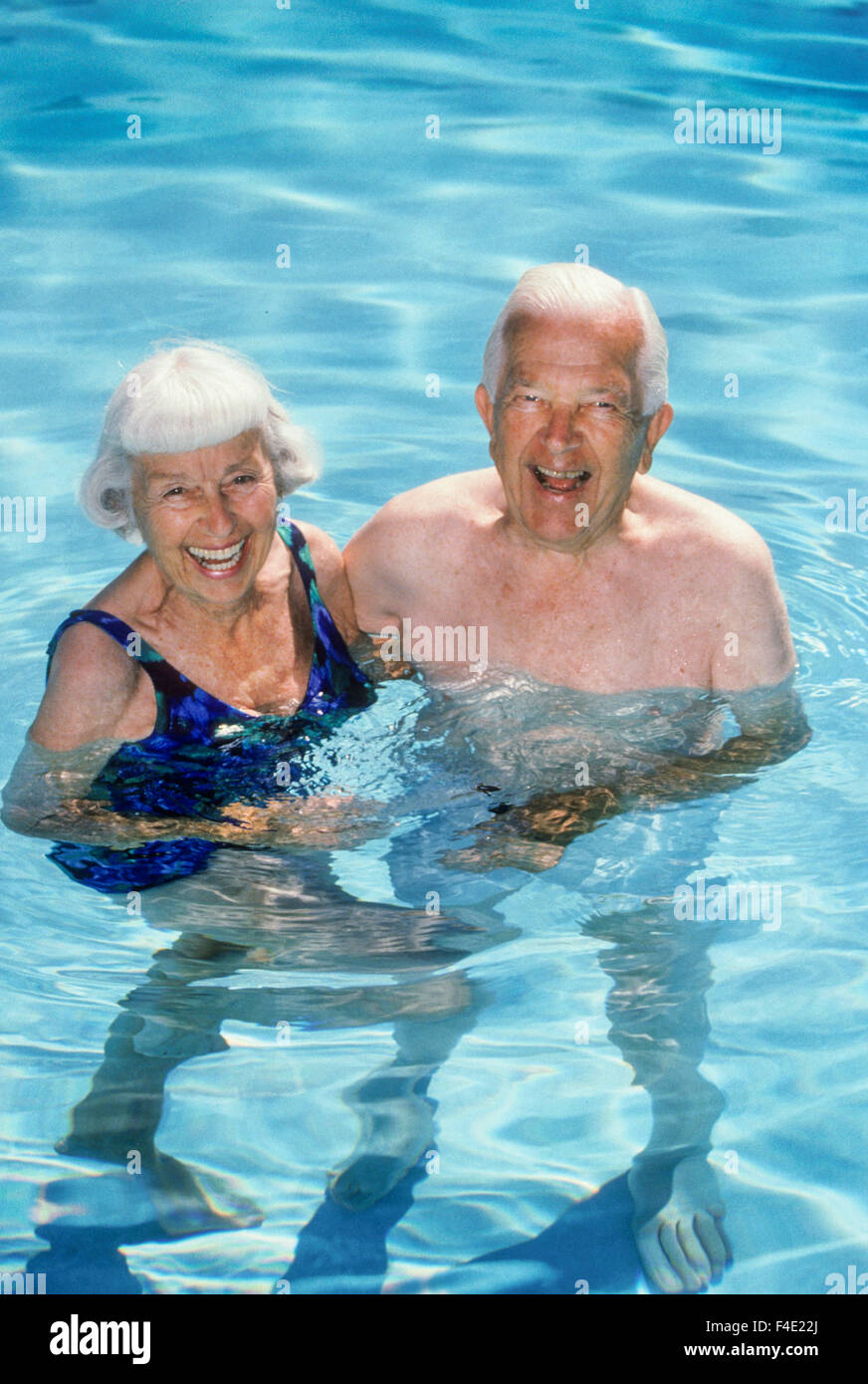 A healthy senior couple swim in a community pool in Laguna Niguel, CA. MODEL RELEASE Stock Photo