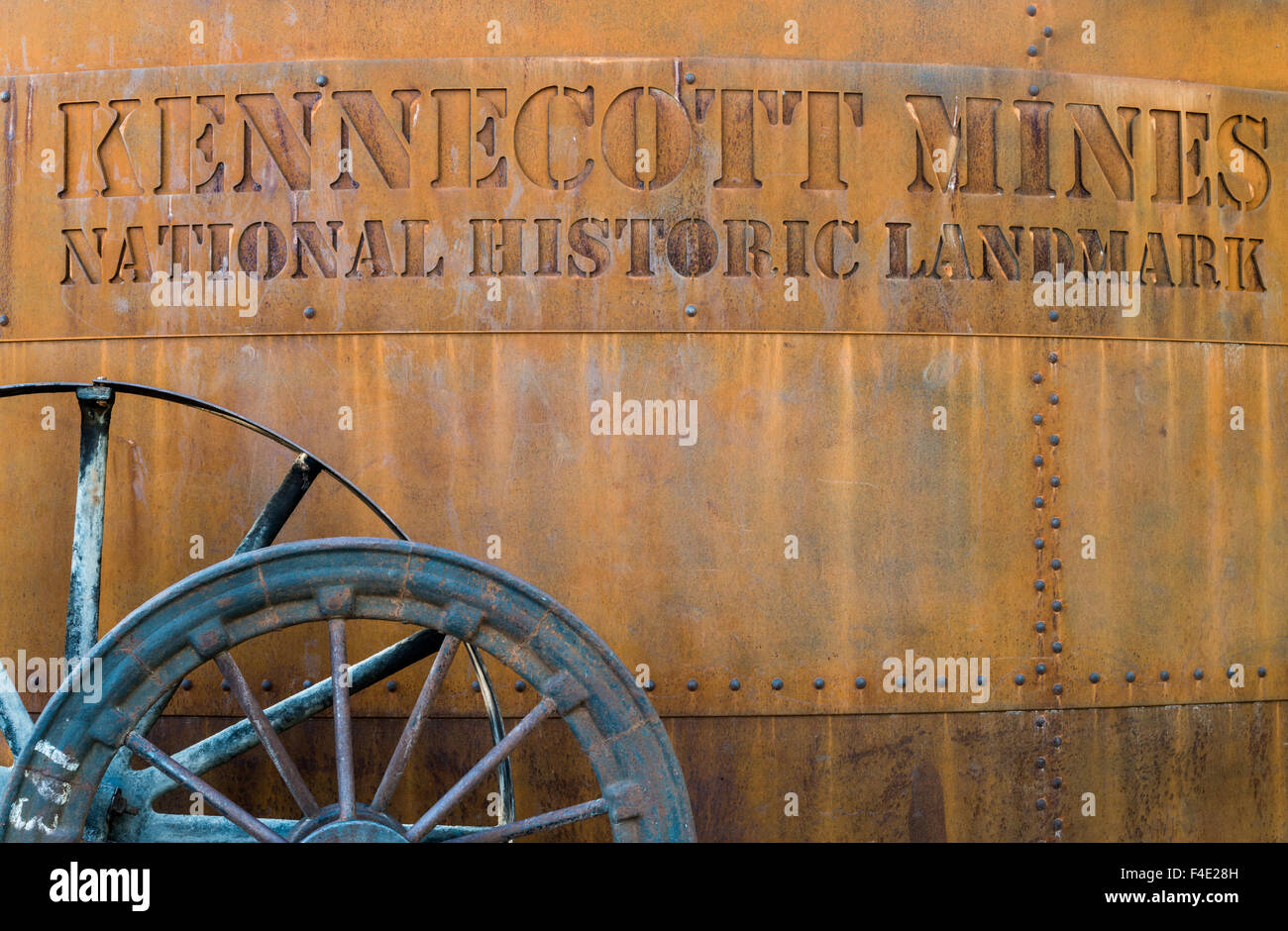 Sign resembling a rusted water tank at entrance to Kennecott Mines National Historic Landmark, Kennicott, Alaska, - Stock Image