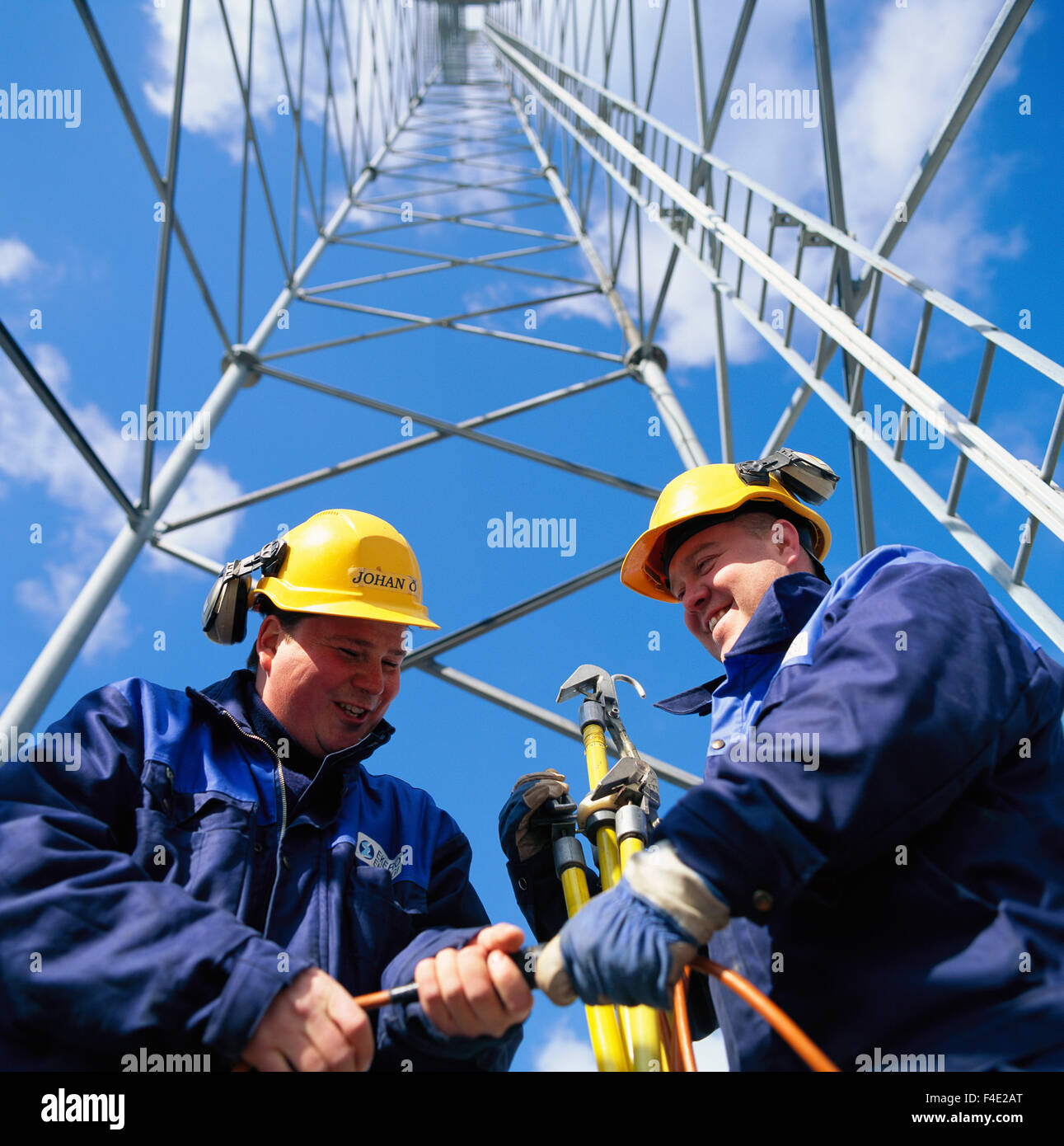 Two men working by a transmission line, Sweden Stock Photo - Alamy