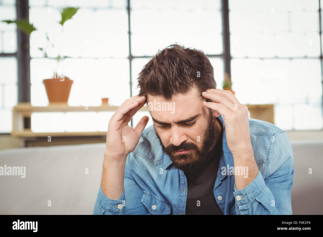 Stressed man hand on forehead Stock Photo