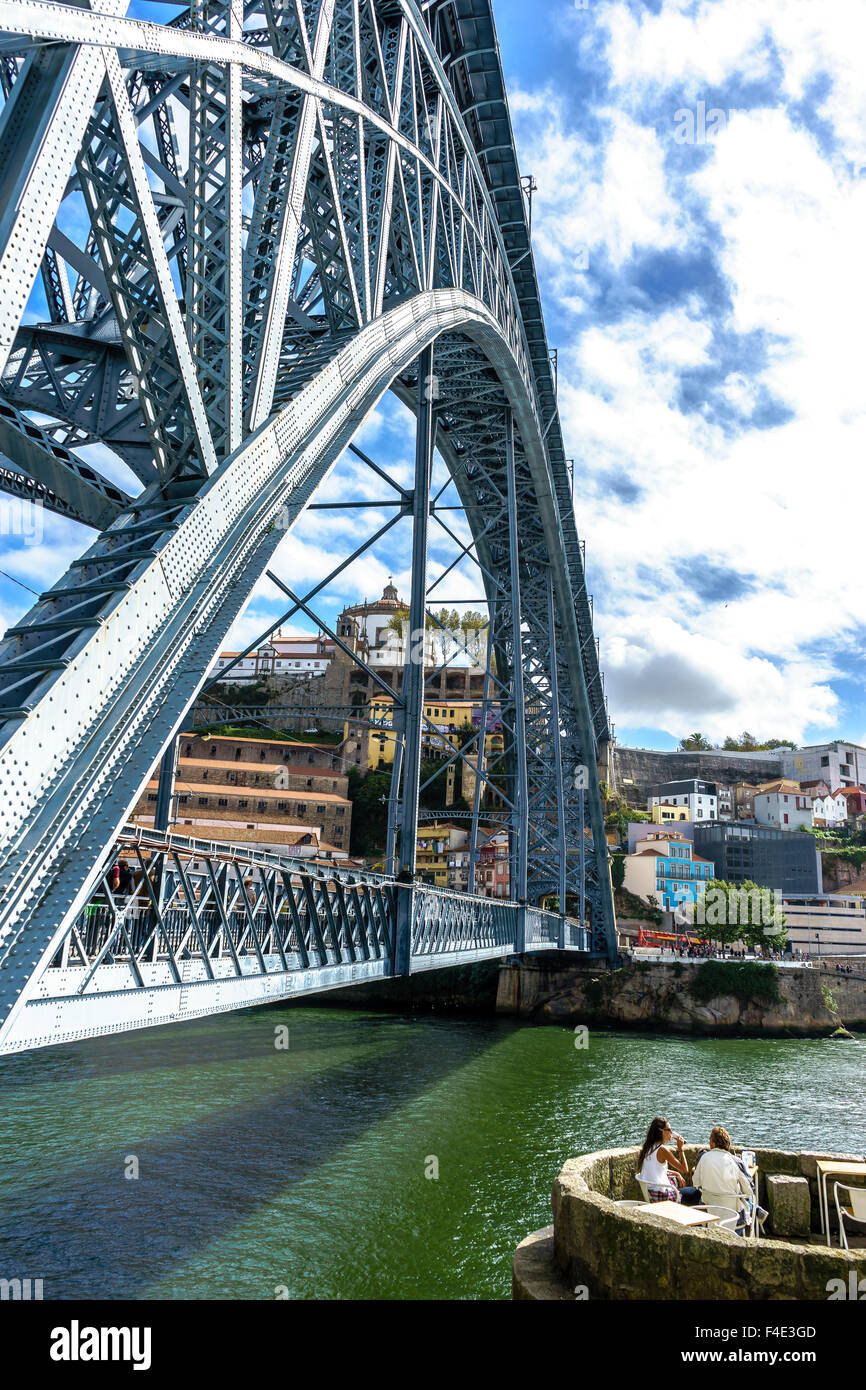COuple has a cocktail on the Ouro River next to the Ponte Luis I bridge in Porto. September, 2015. Porto, Portugal. Stock Photo