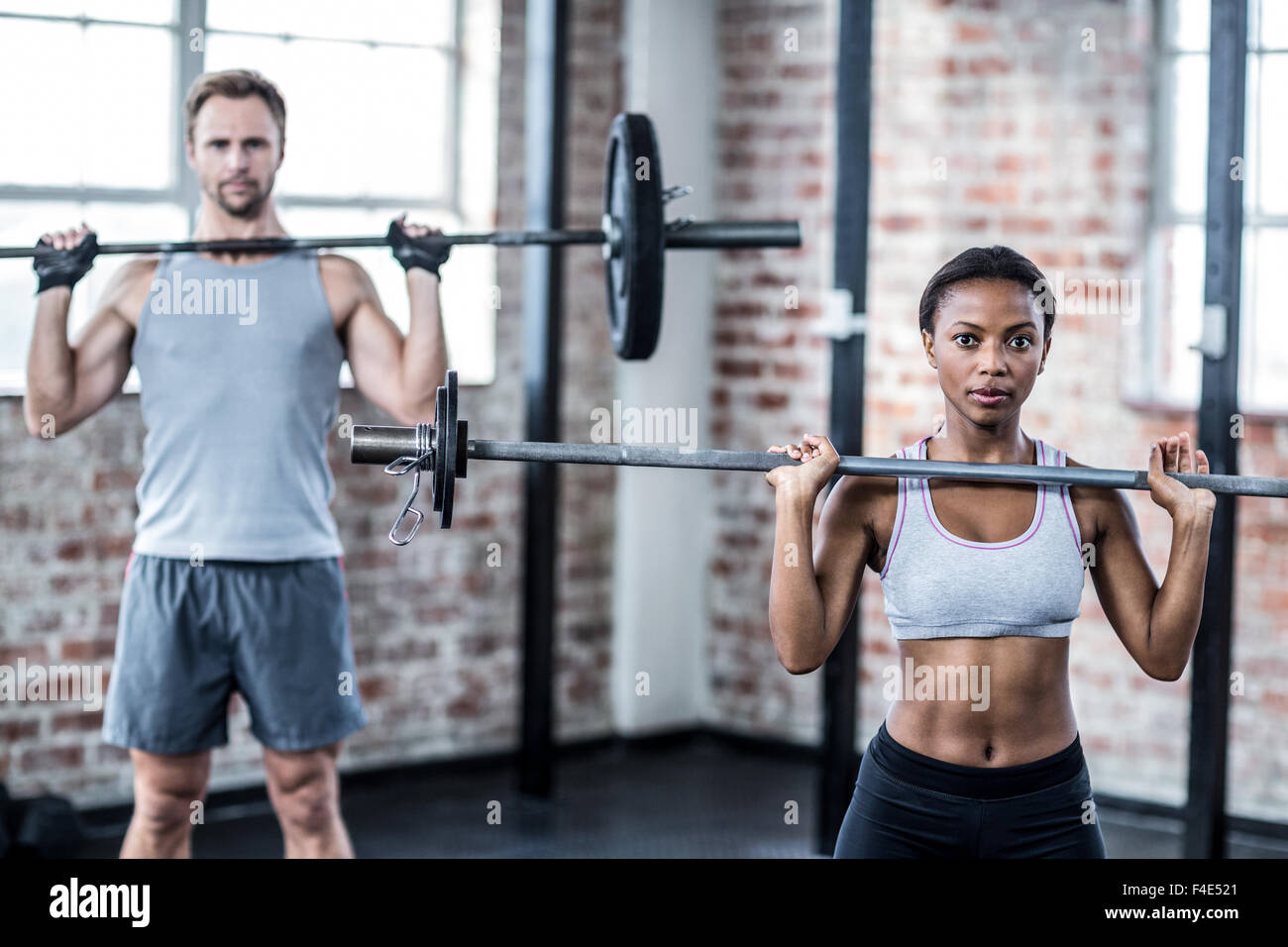 Fit couple lifting weight together Stock Photo - Alamy