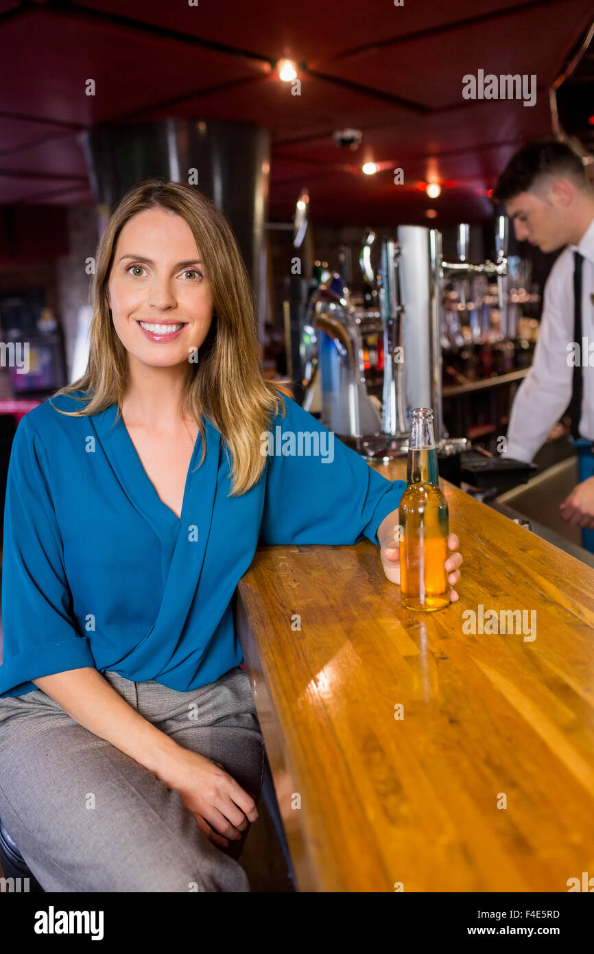 Smiling woman having a drink Stock Photo